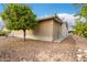 Side view of the home showing the enclosed patio and mature trees in the well-maintained yard at 3301 S Goldfield Rd # 1046, Apache Junction, AZ 85119