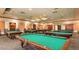 Community game room with multiple billiard tables and overhead lighting for friendly competition at 3301 S Goldfield Rd # 1046, Apache Junction, AZ 85119