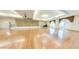 Large hall with wood floors, decorative windows, and stage area perfect for events and gatherings at 3301 S Goldfield Rd # 1046, Apache Junction, AZ 85119
