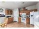 Well-lit kitchen showcasing wooden cabinets, white appliances, and ample countertop space for food preparation at 3301 S Goldfield Rd # 1046, Apache Junction, AZ 85119