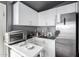 Clean and efficient kitchenette with white cabinets and modern appliances at 3301 S Goldfield Rd # 1046, Apache Junction, AZ 85119