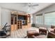 Cozy living room featuring custom built-ins, vaulted ceilings with a fan, a workspace, and comfortable seating at 3301 S Goldfield Rd # 1046, Apache Junction, AZ 85119