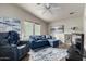 Bright living room featuring a blue sofa, recliner, large windows, and contemporary decor at 3301 S Goldfield Rd # 1046, Apache Junction, AZ 85119
