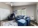 Cozy living room with blue sofa, recliner chair, two windows, and closet for storage at 3301 S Goldfield Rd # 1046, Apache Junction, AZ 85119