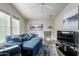Comfortable living room with a blue pull-out sofa, large window, and modern décor at 3301 S Goldfield Rd # 1046, Apache Junction, AZ 85119