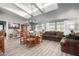 Spacious living room featuring wood floors, a formal dining area, and ample natural light at 3301 S Goldfield Rd # 1046, Apache Junction, AZ 85119
