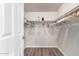 Walk-in closet with wood-look floors, ample hanging space on both sides, and built-in shelves at 3301 S Goldfield Rd # 1046, Apache Junction, AZ 85119