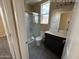 Bathroom featuring a glass door shower and a single vanity with dark wood cabinets at 359 N 157Th Ln, Goodyear, AZ 85338