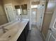 Bathroom with double sinks and large mirror, plus separate door to the toilet/shower area at 359 N 157Th Ln, Goodyear, AZ 85338