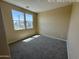 Bedroom features neutral walls, carpeted floor, natural light from two windows, and electrical outlets at 359 N 157Th Ln, Goodyear, AZ 85338