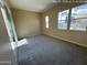 Bedroom with three windows, neutral walls, and carpeted floors providing natural light at 359 N 157Th Ln, Goodyear, AZ 85338