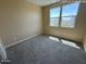 Bright bedroom with carpeted floors, neutral walls, and a window for natural light at 359 N 157Th Ln, Goodyear, AZ 85338