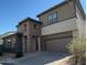Two-story home featuring mixed brick and siding exterior and an attached two car garage at 359 N 157Th Ln, Goodyear, AZ 85338