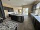 Modern kitchen with gray cabinets, an island with granite counters and stainless steel appliances at 359 N 157Th Ln, Goodyear, AZ 85338