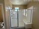 This bathroom showcases a bright, modern shower with bench and window at 359 N 157Th Ln, Goodyear, AZ 85338