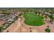 An aerial view of a home featuring a golf course and solar panels at 3702 N 160Th Ave, Goodyear, AZ 85395