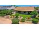 An aerial view showcasing the rear exterior and landscaped yard of the single-story home at 3702 N 160Th Ave, Goodyear, AZ 85395