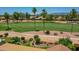 An aerial view of a single-Gathering home shows lush golf course surroundings at 3702 N 160Th Ave, Goodyear, AZ 85395