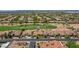 An aerial view of a neighborhood featuring a golf course and desert landscaping at 3702 N 160Th Ave, Goodyear, AZ 85395