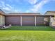 Backyard features green turf lawn and covered patio with window shades to block the sun at 3702 N 160Th Ave, Goodyear, AZ 85395