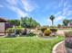 This backyard boasts artifical turf, rock features, mature landscaping, and concrete edging at 3702 N 160Th Ave, Goodyear, AZ 85395