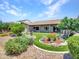 A perfectly manicured backyard with turf and stone accents compliment the exterior of the single story home at 3702 N 160Th Ave, Goodyear, AZ 85395