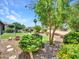 Lush backyard featuring artificial turf, rocks, desert landscaping, and mature trees at 3702 N 160Th Ave, Goodyear, AZ 85395