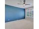 Bedroom featuring an accent wall, ceiling fan, and shuttered window at 3702 N 160Th Ave, Goodyear, AZ 85395