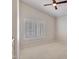 Bedroom with neutral carpet, shuttered windows, and a ceiling fan at 3702 N 160Th Ave, Goodyear, AZ 85395