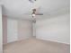 Spacious bedroom with neutral carpet, two entry doors, and a ceiling fan at 3702 N 160Th Ave, Goodyear, AZ 85395