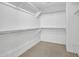 Walk-in closet featuring carpeted floors and built-in shelving at 3702 N 160Th Ave, Goodyear, AZ 85395