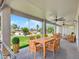 Covered patio with comfortable wicker furniture and a dining table overlooking the backyard at 3702 N 160Th Ave, Goodyear, AZ 85395