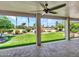 Covered patio offering a beautiful view of the landscaped backyard with artificial turf at 3702 N 160Th Ave, Goodyear, AZ 85395