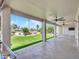 Extended covered patio with ceiling fans offers views of landscaped backyard with artificial turf at 3702 N 160Th Ave, Goodyear, AZ 85395