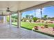 Relaxing covered patio overlooking the manicured backyard and lush landscaping at 3702 N 160Th Ave, Goodyear, AZ 85395