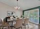 Stylish dining room featuring an elegant chandelier, and a sliding glass door at 3702 N 160Th Ave, Goodyear, AZ 85395