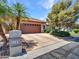 A well-maintained home featuring a spacious driveway, mature landscaping, and a charming exterior with a tile roof at 3702 N 160Th Ave, Goodyear, AZ 85395