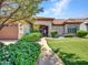 Attractive home with mature landscaping, a curved walkway, and a charming front entrance with a tile roof at 3702 N 160Th Ave, Goodyear, AZ 85395