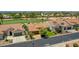 Inviting single-Gathering home with a tile roof, solar panels, lush green lawns, and mature trees bordering a golf course at 3702 N 160Th Ave, Goodyear, AZ 85395