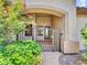 Inviting front porch with an ornate metal gate surrounded by lush greenery and a charming residential facade at 3702 N 160Th Ave, Goodyear, AZ 85395