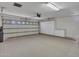Attached garage with epoxy flooring, storage cabinets, and an automatic door system at 3702 N 160Th Ave, Goodyear, AZ 85395
