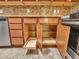 Kitchen cabinet showing sliding shelves and storage, adjacent to stainless steel appliances at 3702 N 160Th Ave, Goodyear, AZ 85395