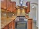 Stylish kitchen with stainless steel range hood and a cooktop, beautiful backsplash, and ample cabinet space at 3702 N 160Th Ave, Goodyear, AZ 85395