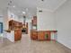 Open concept kitchen features stainless appliances, granite counters, tile floors, and seamless design at 3702 N 160Th Ave, Goodyear, AZ 85395