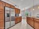 Spacious kitchen with stainless steel refrigerator, granite countertops, pendant lights, and tile floors at 3702 N 160Th Ave, Goodyear, AZ 85395