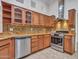 Modern kitchen boasts stainless steel appliances, a decorative backsplash, and sleek countertops for cooking enjoyment at 3702 N 160Th Ave, Goodyear, AZ 85395
