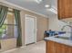 Laundry room with granite countertops, utility sink, window, and washer/dryer at 3702 N 160Th Ave, Goodyear, AZ 85395