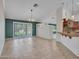 Open-concept living space, featuring tiled flooring and a sliding glass door for natural light at 3702 N 160Th Ave, Goodyear, AZ 85395