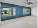 Bright living room with large windows offering a view of lush landscaping, ceiling fan, and neutral carpet at 3702 N 160Th Ave, Goodyear, AZ 85395