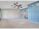 Spacious living room with a ceiling fan, neutral walls, and plush carpeting, ready for your personal touch at 3702 N 160Th Ave, Goodyear, AZ 85395